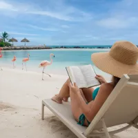 Woman reading the an Aruba book on Flamingo Island
